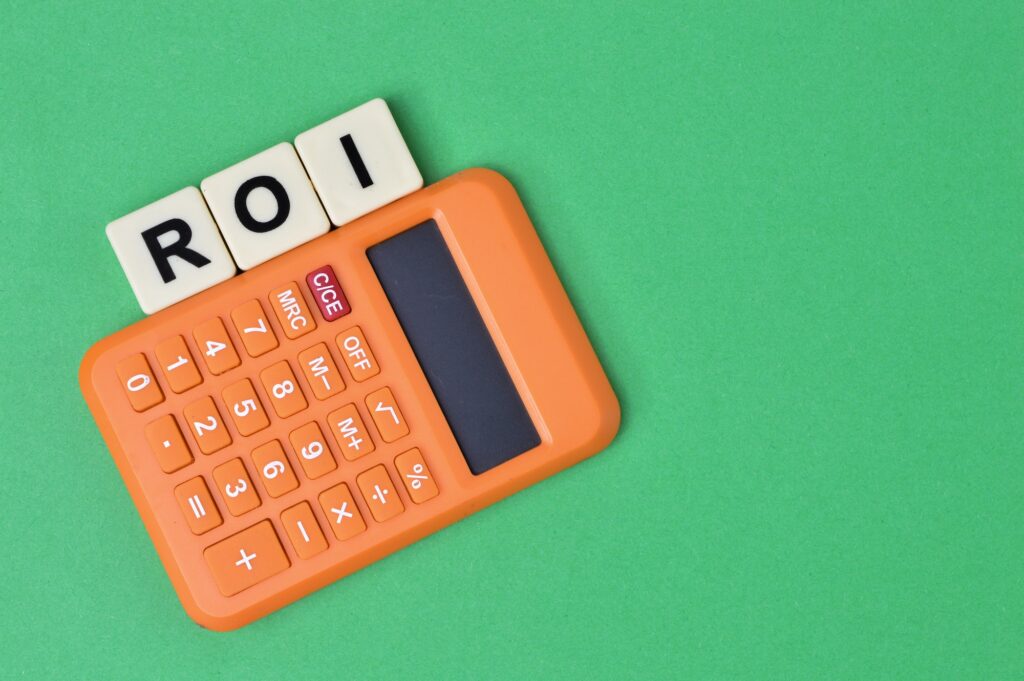 scrabble letters with text ROI stands for Return On Investment.
